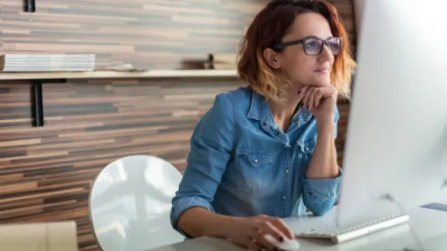 A woman looking at her monitor