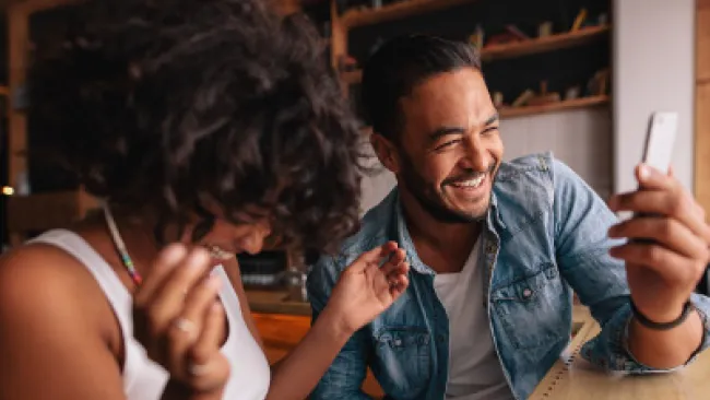 Two people giggling