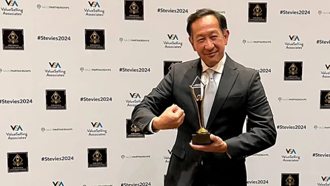 Mall Tech Global's Philip Say holding a Gold Stevie Award. 