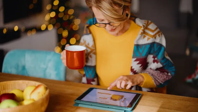 Woman shopping on her tablet during holiday time