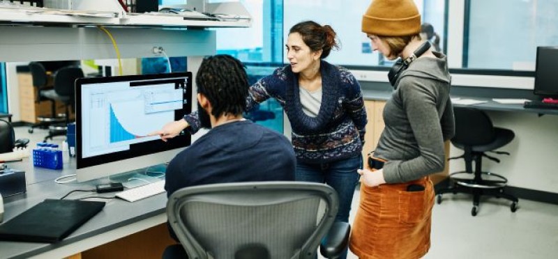 3 people analyzing data
