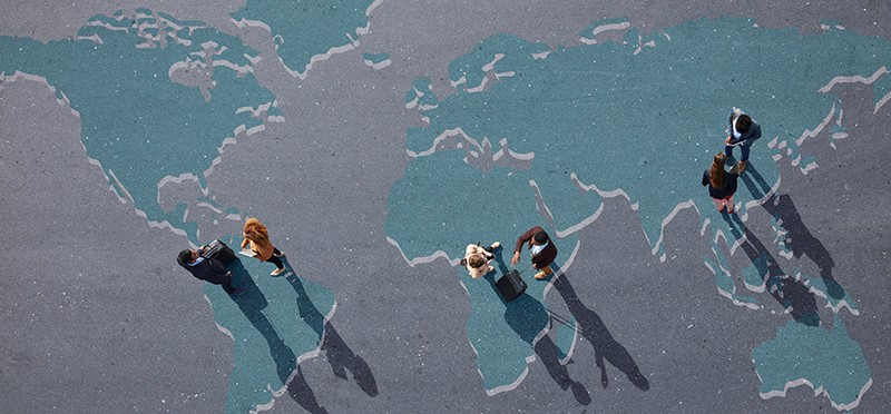 Group of people standing over world map